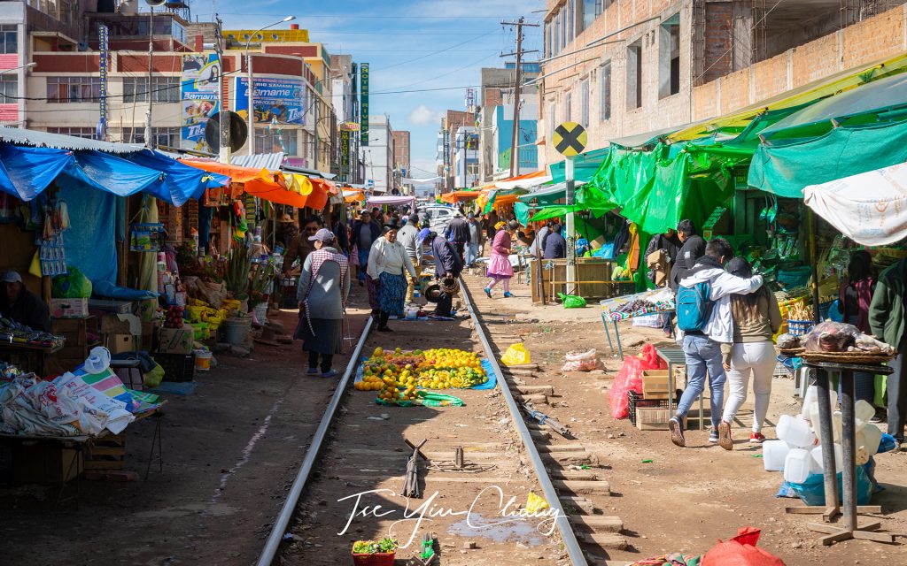 A fascinating glimpse of everyday life of the Peruvian Andes as the train tracks cut right through the middle of the Juliaca town market, with the stalls passing within touching distance