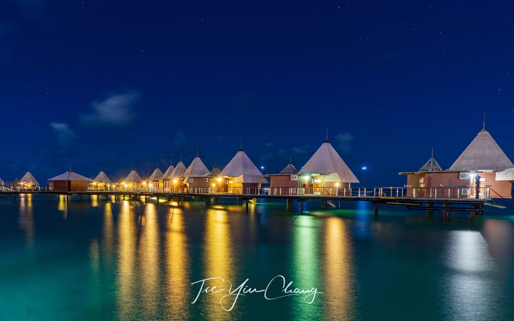 Overwater bungalow at night